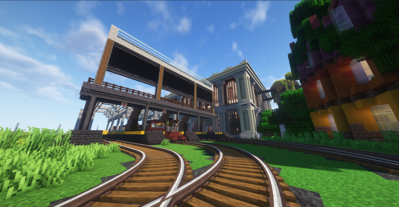 A Create mod train station with curving tracks in sunlight